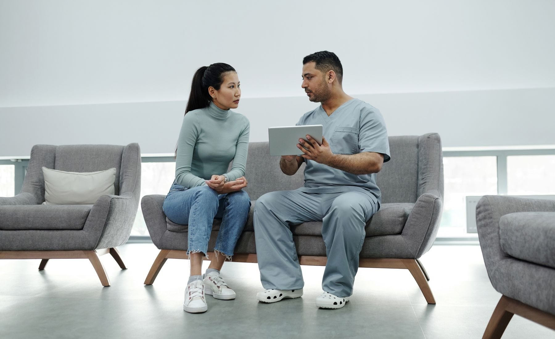 Healthcare provider talking with a patient at home
